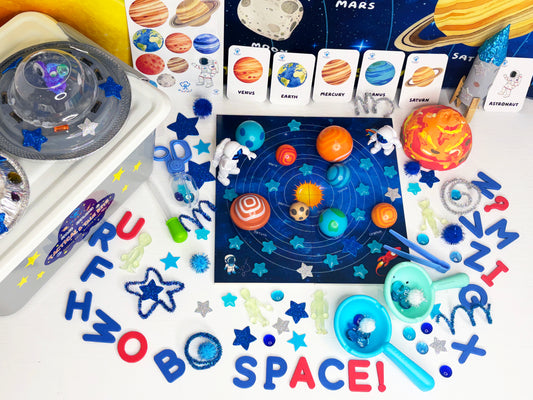 Educational space-themed toys and materials on a white background